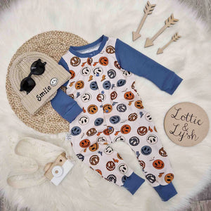 Lottie & Lysh flat lay image featuring the vintage smiling face romper, smile beanie hat and accessories 