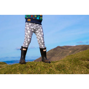 dino moon boys leggings worn with hunter boots by a young boy