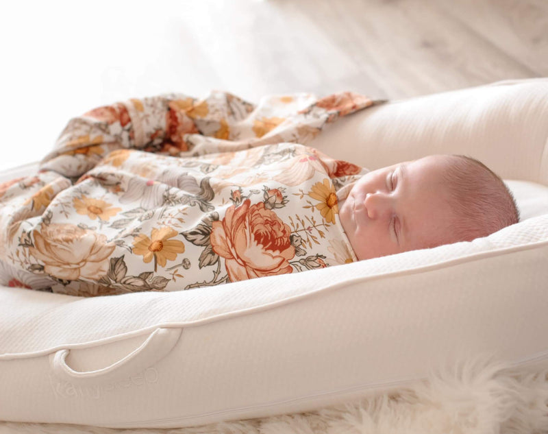 Floral baby swaddle and blanket