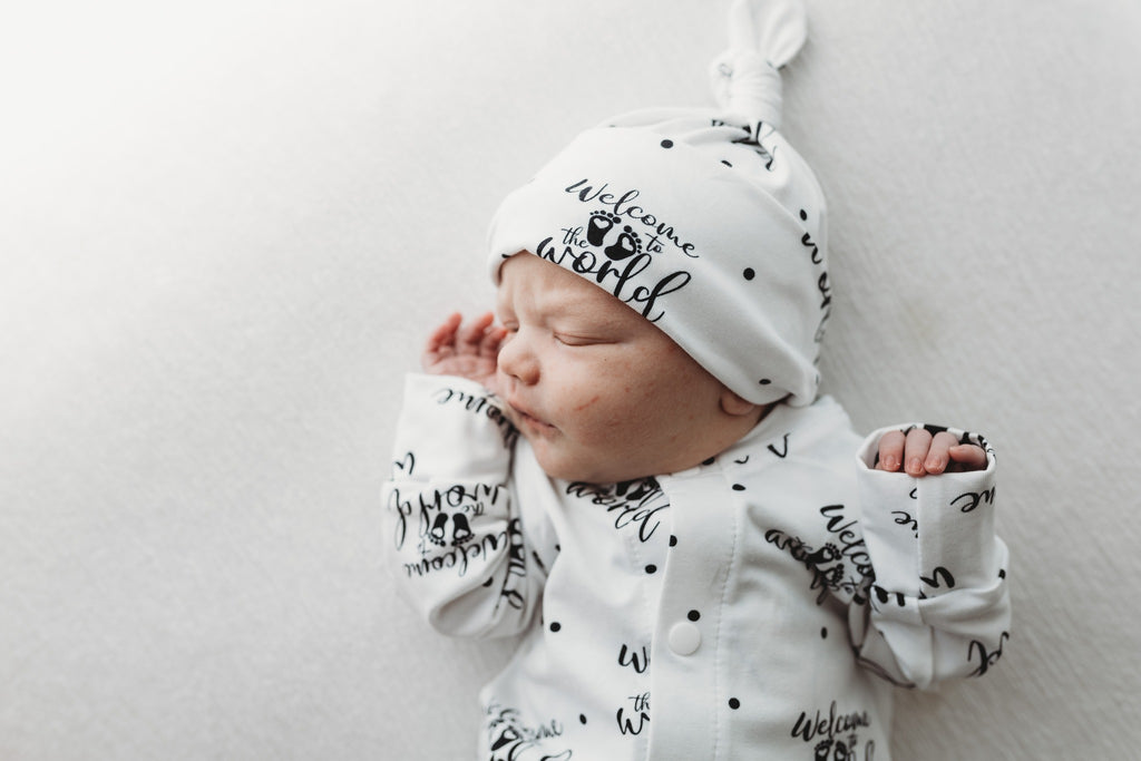 unisex coming home outfit for newborn babies featuring Welcome to the world print by Lottie & Lysh with coordinating hat