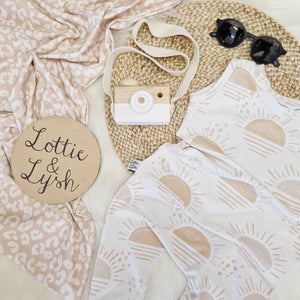 neutral baby romper with sun rise print detail