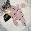 puffin print baby and toddler dungarees by Lottie & Lysh. Pictured on an industrial floor, with white fluffy rug, black beanie and hat and orange sunglasses