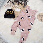 flay lay image featuring puffin print baby and toddler dungarees, black beanie knitted hat and orange sun glasses