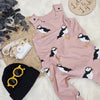 kids outfit flay lay featuring puffing romper, black hat and orange sunglasses