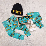 UK made baby boy leggings with buzzin bees graphic print details. Pictured with a black knitted beanie hat, and yellow sunglasses