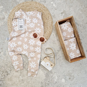 beige baby romper for summer with white flowers