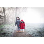 brother and sister wearing lottie & lysh dino jacket with hood spikes and red quilted bunny jacket in the mist and trees
