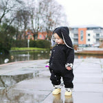 cute baby girl wearing lottie & lysh monochrome bunny pramsuit with splatter effect lining and yellow boots