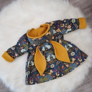 floral jacket with mustard lining featuring bunny ears on the hood.