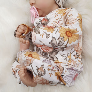 new baby wearing floral printed babygrow by Lottie & lysh