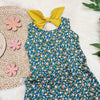 Green and pink floral fabric used in a kid's bow back summer romper by Lottie & Lysh