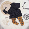 outfit inspiration for baby boys featuring Lottie & Lysh checkboard leggings, black t-shirt and beige knitted beanie hat