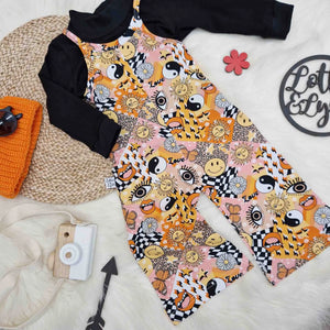 seventies printed playsuit for kids paired with a black turtle neck top