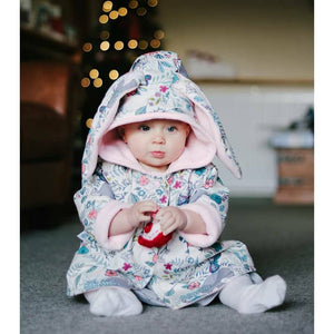cute baby girl wearing a jacket with bunny ears in white floral