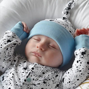 baby boy wearing lottie & Lysh monosplatter and blue romper with matching hat