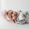 newborn baby girl baby girl wearing Lottie & Lysh welcome to the world babygro with baby pink baby turban headwrap