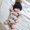 sleeping baby boy wearing lottie & Lysh wild campers bummies and tshirt set with a pom hatmmie