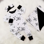 New baby gift set comprising a romper, blanket and headband made with Lottie & lysh's Welcome to the world fabric which is white with black writing. The gift is accented with black accents