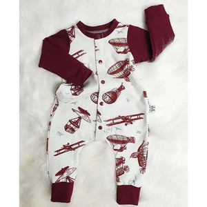 vintage modes of air travel transport hand drawn on a cream background accented with burgundy. Longsleeve baby romper in organic jersey by Lottie & Lysh