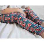 fire engine toddler leggings worn by a boy sitting on a bed