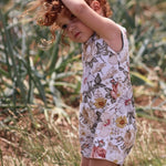 little girl wearing a floral short playsuit made by Lottie & Lysh