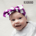 Baby girl wearing a lottie & lysh knotted headband in purple with white cloud print