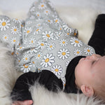 baby girl wearing Lottie & Lysh daisy print romper over a black top