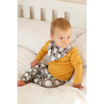 penguin print bandana bib and matching baby leggings paired with a long sleeve mustard top modelled by a 