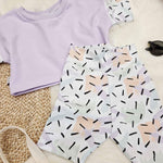 90s style kids outfit. Lilac crop top and confetti print cycling shorts